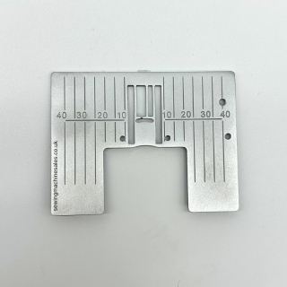 Needle plate with metric markings