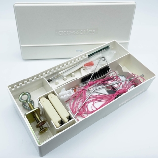 Accessory box full of tools and accessories for knitting machines